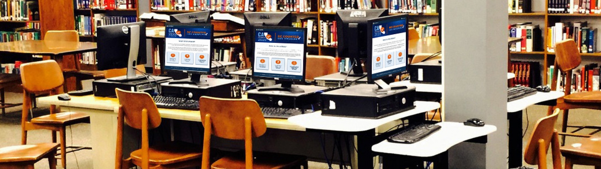 Banner of a library setting with multiple desktop computers displaying images of California Map Logo with text Census 2020 Be Counted Los Angeles.